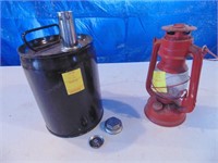 black gas can with spout and red kerosene lantern