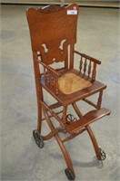 ANTIQUE WOODEN HIGH CHAIR WITH METAL WHEELS
