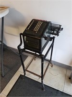 Adding machine on stand