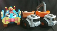 2 toy construction trucks & Elmo ride-on