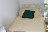 Bed with mattress and linens