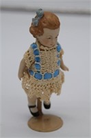 Antique porcelain doll on stand