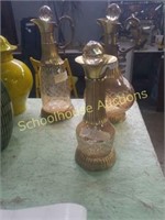Group of 3  decanters.  Glass is a rose gold