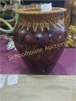 Brown vase with wicker top.