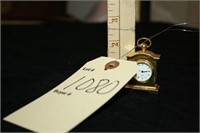Miniature brass mantle clock