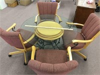 Glass top table and 4 roller chairs