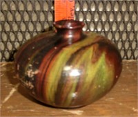 3 1/2" redware vase w/swirled metallic glaze has