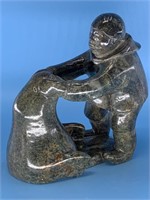 Soapstone carving of a hunter and walrus, unsigned