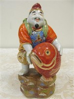 Asian figure holding a fish