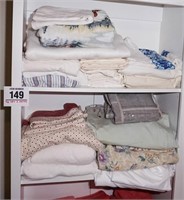 Linens on left side of top 2 shelves - variety of