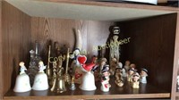 Shelf of Homco figurines, bells, candle holder
