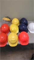 9 used hard hats, and one face shield