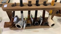Pipe stand with six vintage smoking pipes