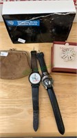 Two wrist watches, brooch, and a leather