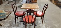 Small table with four red chairs