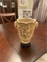 Ivory colored elephant handled Carved vase
