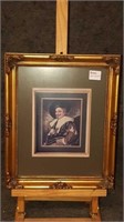 Print of a petit point in a beautiful gold frame