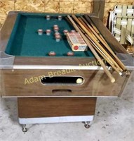 Vintage bumper pool table with pool balls and cue