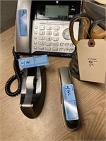 Office phone with pen holder, stapler, and tap