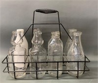 Early Bottle Rack with Many Dairy Bottles