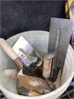 bucket of concrete and plaster tools