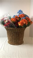 Artificial flowers in wicker basket
