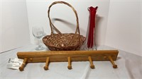 Wooden coat rack, wicker basket, wine glass, and