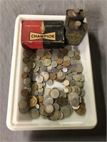 Foreign coins, old spark plugs, lube oil tins