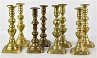 FOUR PAIRS OF BRASS CANDLESTICKS