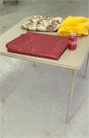 Card table with plastic table cloths.