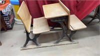 Antique wooden student desk with metal legs.