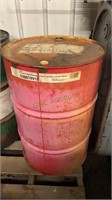 55 gallon red metal drum with oil, appears to be