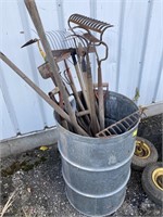 Barrel of miscellaneous yard tools