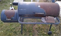 Kettle charcoal grille with side smoker.