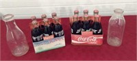 2 Coca cola six packs, 2 milk bottles