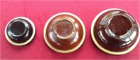 Three brown stoneware bowls