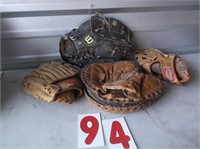 lot of old baseball gloves