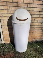 White garbage can with lid.