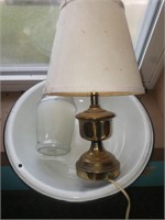Enamel pan, candle and lamp.