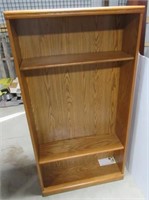 Oak bookshelf with 3 wood shelves. Measures 62" H