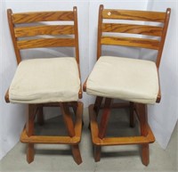 Matching pair of oak swivel bar stools. Note one