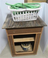 Rolling cabinet with peg board, garden hose, and