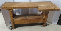 Rolling wood work bench. Measures 34" H x 60" W x