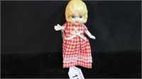 MINIATURE PORCELAIN DOLL WITH RED CHECKERED DRESS