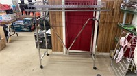 Large clothing rack with top rack storage.