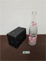 Antique camera and glass bottle