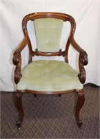 Walnut Carved arm chair with green velvet button