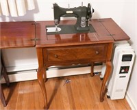 White electric sewing machine in mahogany