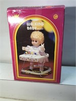 Vintage battery-operated walking baby doll and