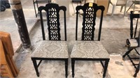 2 black padded seat chairs